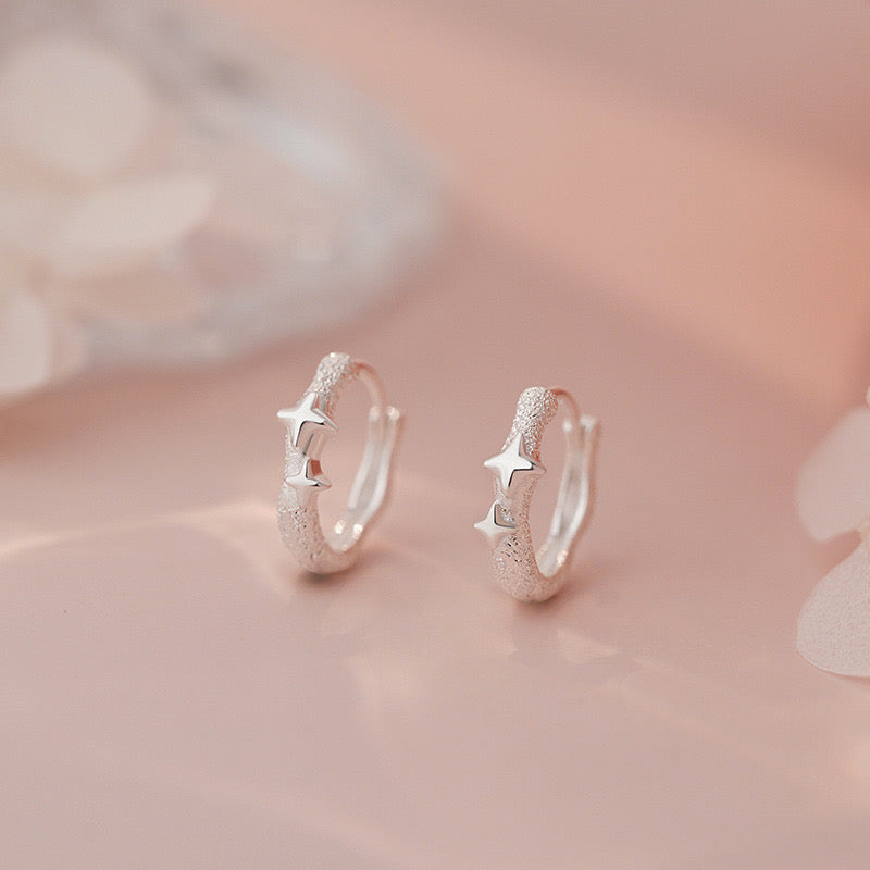 Four pointed stars frosted huggie earrings