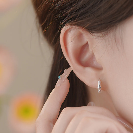 Four pointed stars frosted huggie earrings